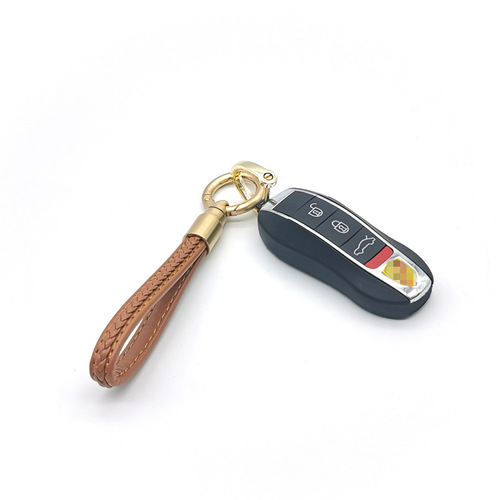 Creative bullet-shaped rotating keychain for men and women, genuine leather car keychain, alloy pendant, advertising gift item.