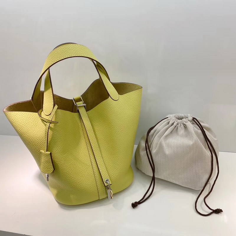 El nuevo bolso de cesta de verduras de marea de cuero togo de piel de vaca de capa superior 2025, bolso de cubo con cerradura de mano, bolso de cuero para mujer