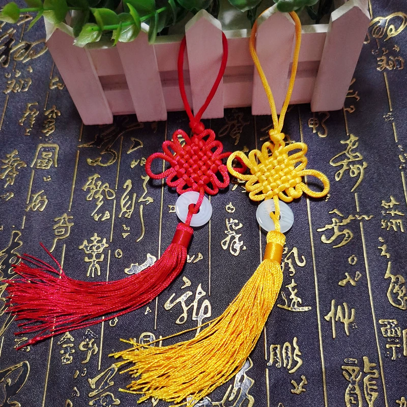 Small red pendant with tassels, strap, protective amulet