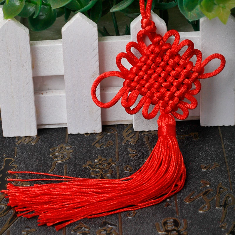 Small red pendant with tassels, strap, protective amulet