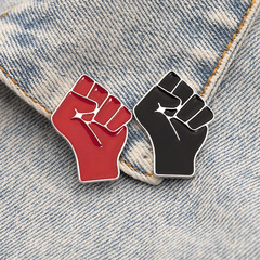 Black Lives Matter slogan with a fist symbol, alloy drop-shaped pin with oil texture, and a denim backpack badge.
