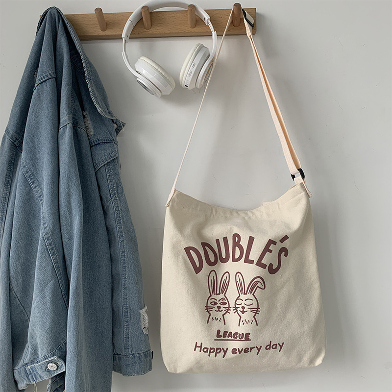 Bolso de lona bolso cruzado para mujer 2025 nuevo estilo estilo japonés versátil bolso de hombro de dibujos animados de gran capacidad bolso de tela para estudiantes estilo k