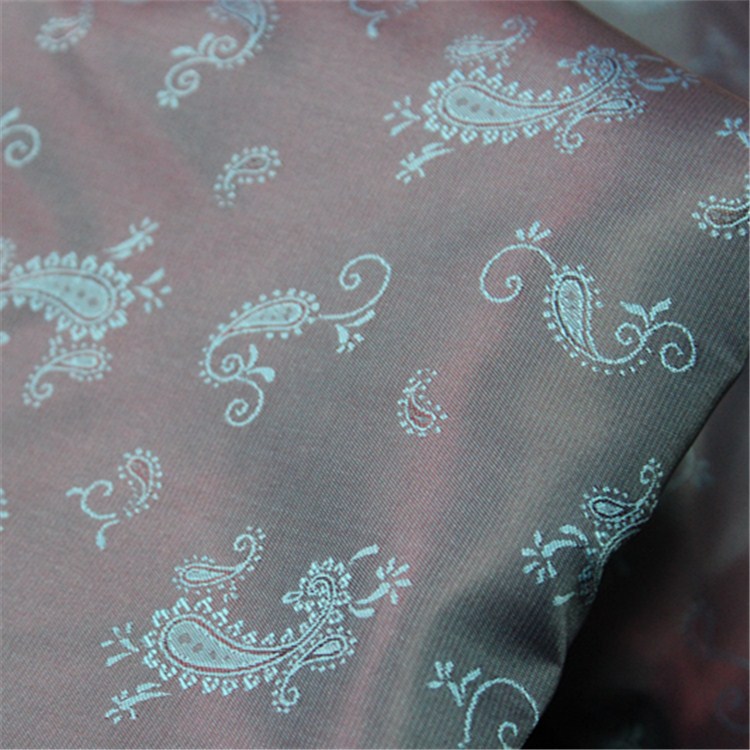 琨鹏纺织现货供应服装里布西装休闲涤纶提花布琵琶花