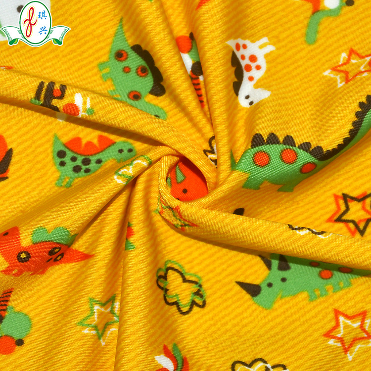 供应印花泳衣面料 卡通恐龙泳装布料 宝宝儿童泳衣布水印