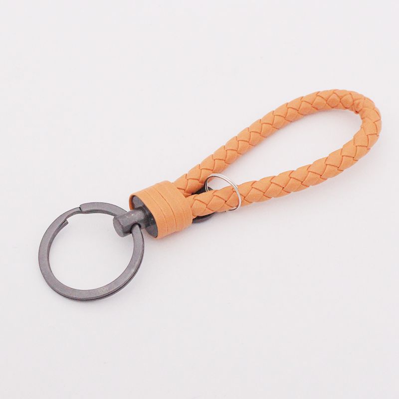 Llavero de acero de tungsteno para hombres y mujeres llavero de coche cuerda de cuero tejida hecha a mano par llavero colgante letras