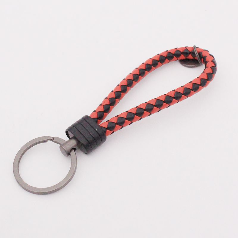 Llavero de acero de tungsteno para hombres y mujeres llavero de coche cuerda de cuero tejida hecha a mano par llavero colgante letras