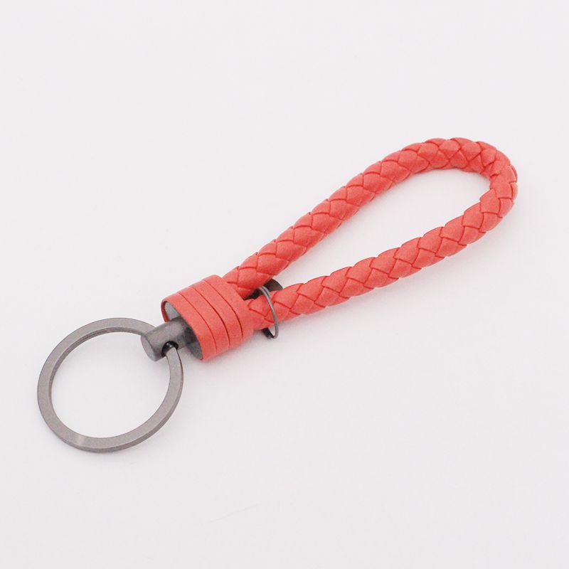 Llavero de acero de tungsteno para hombres y mujeres llavero de coche cuerda de cuero tejida hecha a mano par llavero colgante letras