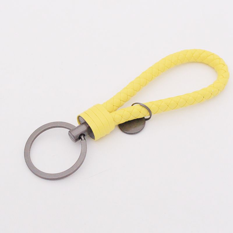 Llavero de acero de tungsteno para hombres y mujeres llavero de coche cuerda de cuero tejida hecha a mano par llavero colgante letras