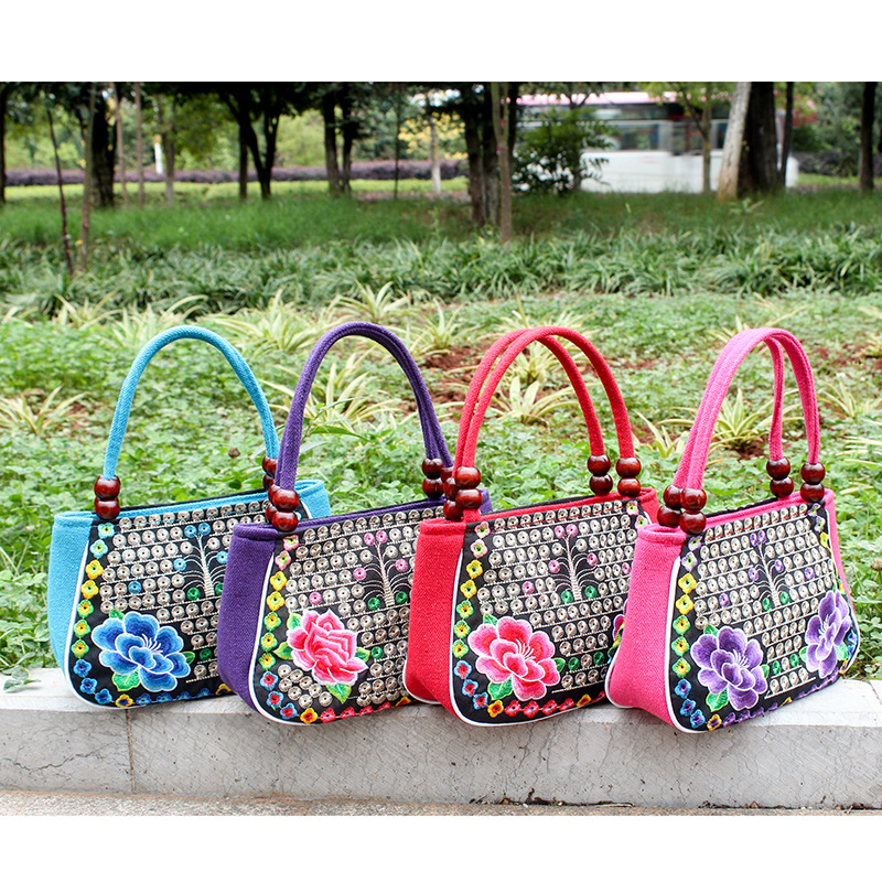 Directo de fábrica nuevo estilo étnico bordado bolsa cobre moneda flor pequeño bolso Yunnan bordado bolso especial Miao bordado bolsa