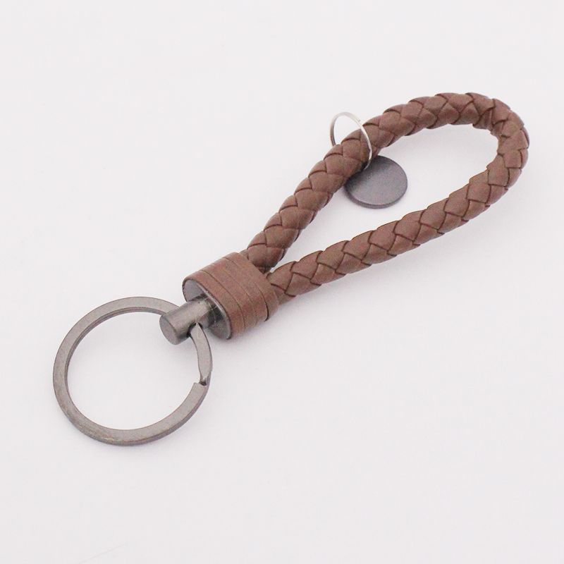 Llavero de acero de tungsteno para hombres y mujeres llavero de coche cuerda de cuero tejida hecha a mano par llavero colgante letras