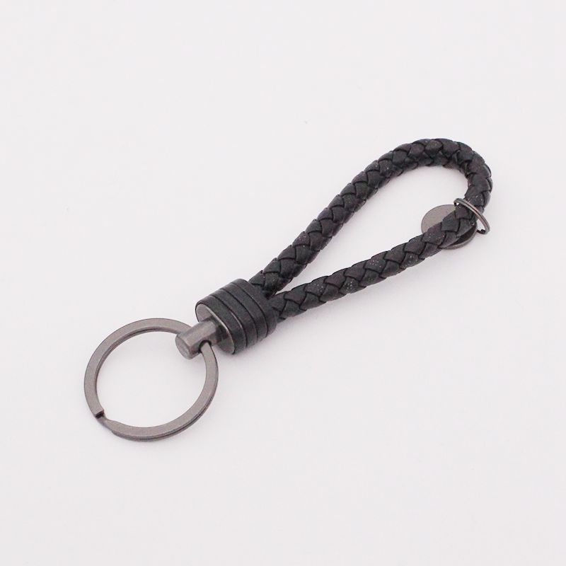 Llavero de acero de tungsteno para hombres y mujeres llavero de coche cuerda de cuero tejida hecha a mano par llavero colgante letras