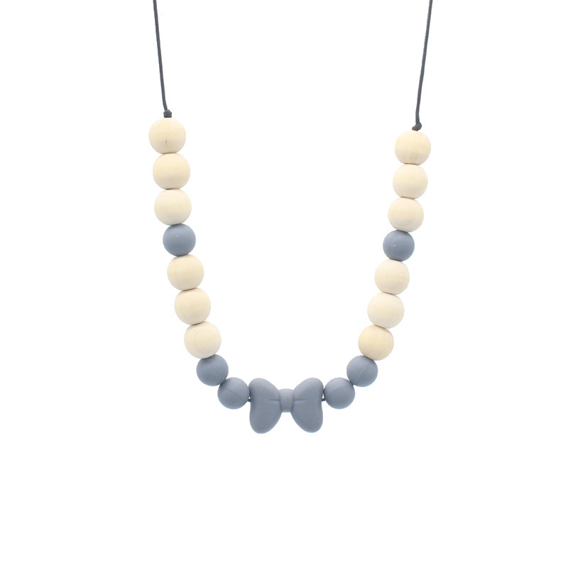 Bebé arco mordedor collar bebé joyería de los niños mordedor palo de silicona collar de cuentas de madera mordida colgante de pegamento