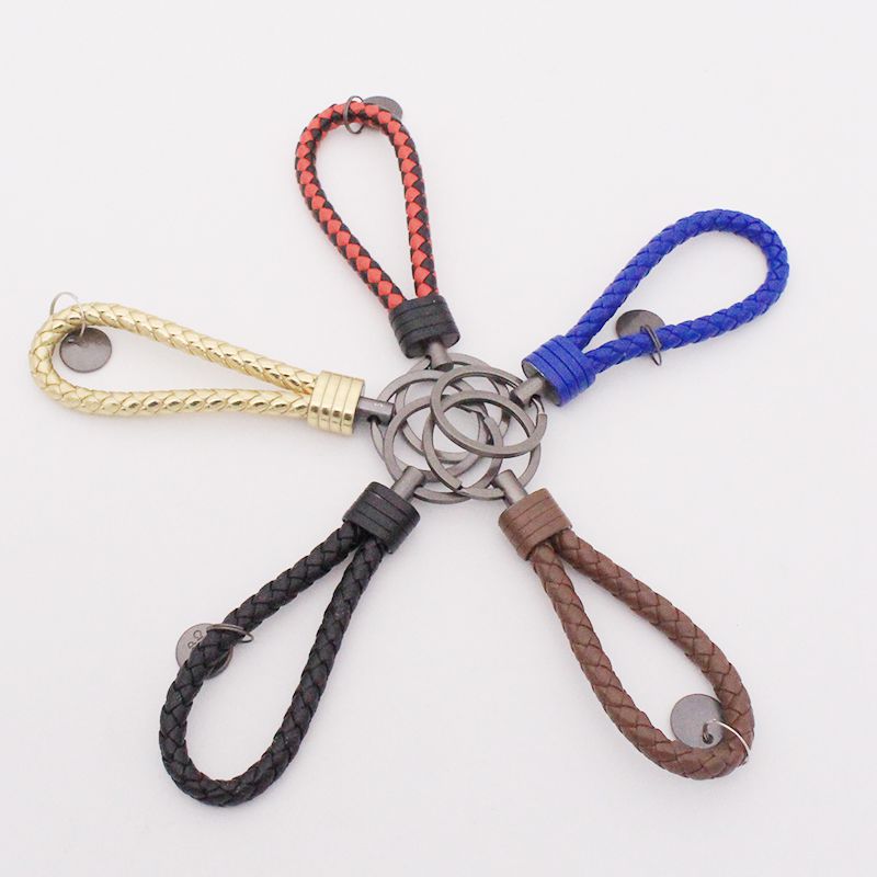 Llavero de acero de tungsteno para hombres y mujeres llavero de coche cuerda de cuero tejida hecha a mano par llavero colgante letras
