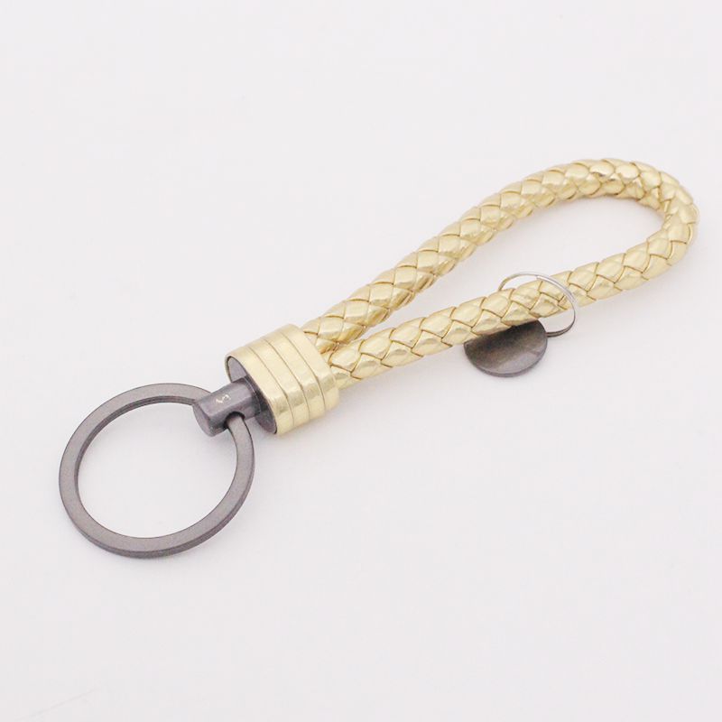 Llavero de acero de tungsteno para hombres y mujeres llavero de coche cuerda de cuero tejida hecha a mano par llavero colgante letras