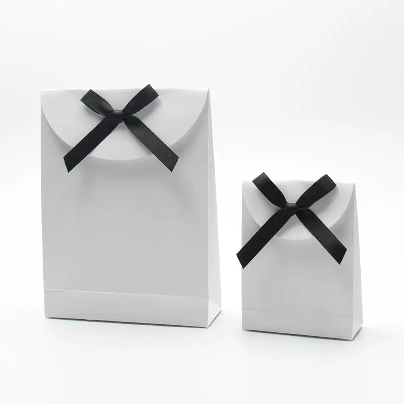 定做节日礼品袋粘贴式礼物包装纸袋精美蝴蝶结化妆品铜版纸包装袋