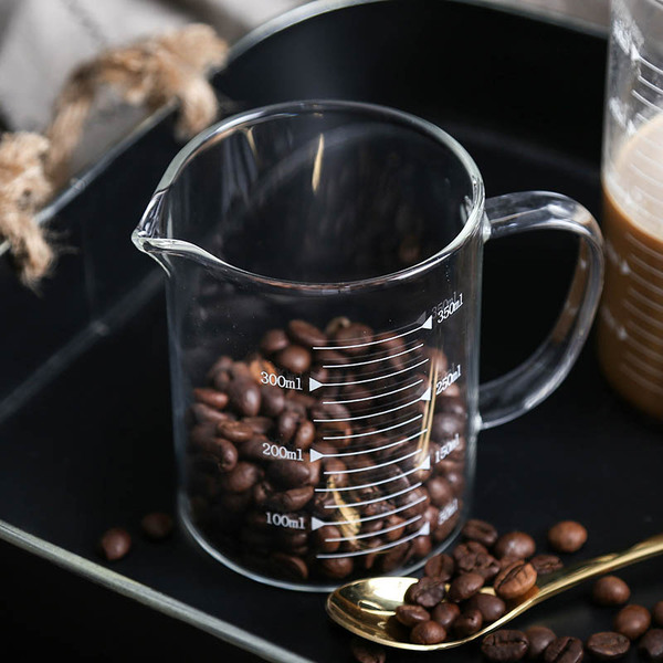 Transparent glass measuring cup scaled