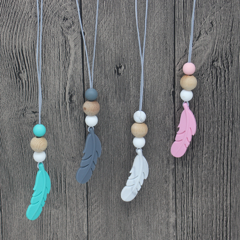 Amazon nueva pluma mordedor collar bebé calmante molar silicona seguridad ambiental Beech bead collar