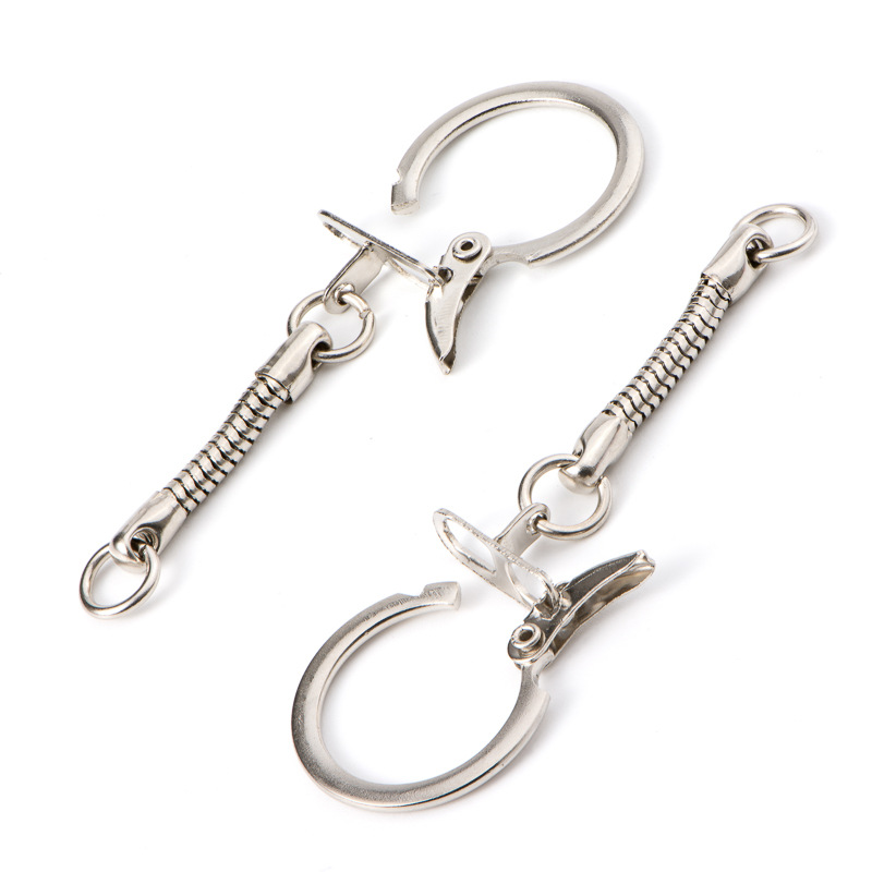 Two silver wing hook keychain attachments (also known as chicken wing clasps) with coiled chains and keyrings.