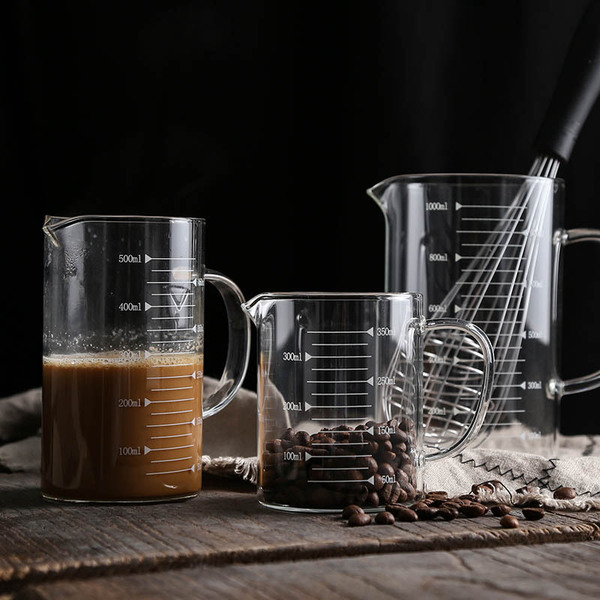 Transparent glass measuring cup scaled