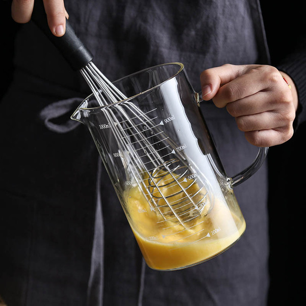Transparent glass measuring cup scaled