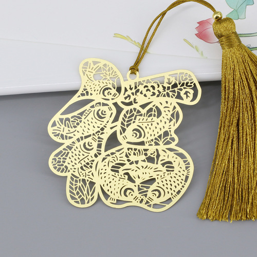 Chinese-style, intricate hollow metal tassel bookmark with a Buddha-like design, exquisitely crafted gift