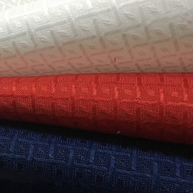 厂家直销大方格跆拳道服面料涤棉布提花运动漂白跆拳道面料