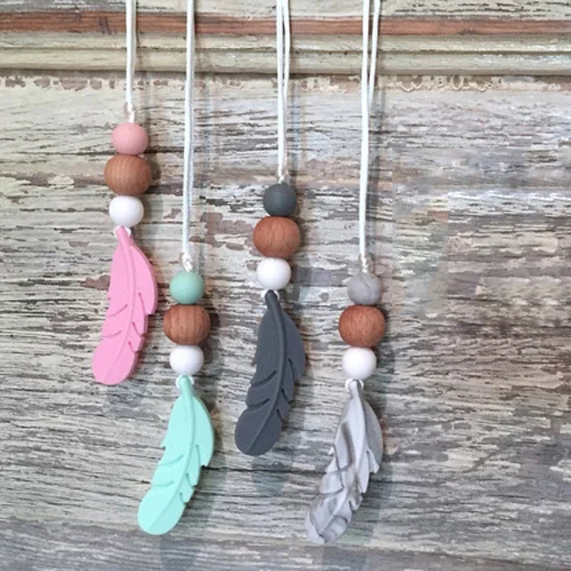 Amazon nueva pluma mordedor collar bebé calmante molar silicona seguridad ambiental Beech bead collar