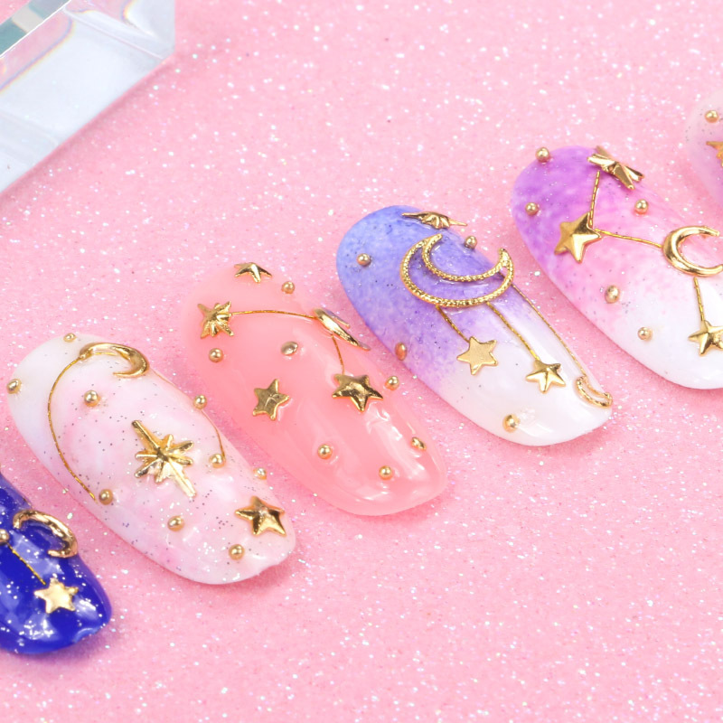 Joyas de belleza de uñas de la estrella y la luna, remaches de estampado de oro, bolas de acero mezcladas con anillo de metal, diamante de agua, diafragma de aleación hueca japonesa