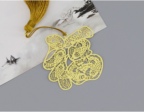 Chinese-style, intricate hollow metal tassel bookmark with a Buddha-like design, exquisitely crafted gift
