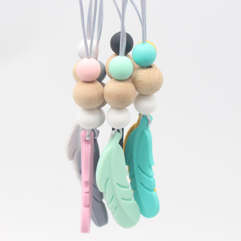 Amazon nueva pluma mordedor collar bebé calmante molar silicona seguridad ambiental Beech bead collar