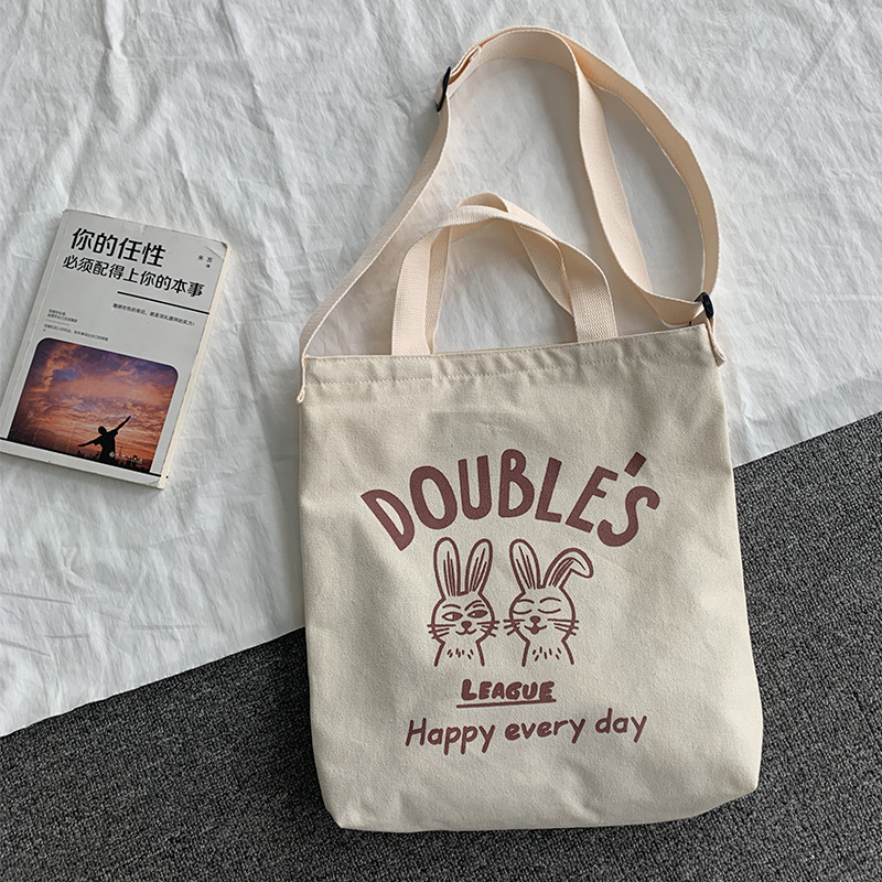 Bolso de lona bolso cruzado para mujer 2025 nuevo estilo estilo japonés versátil bolso de hombro de dibujos animados de gran capacidad bolso de tela para estudiantes estilo k