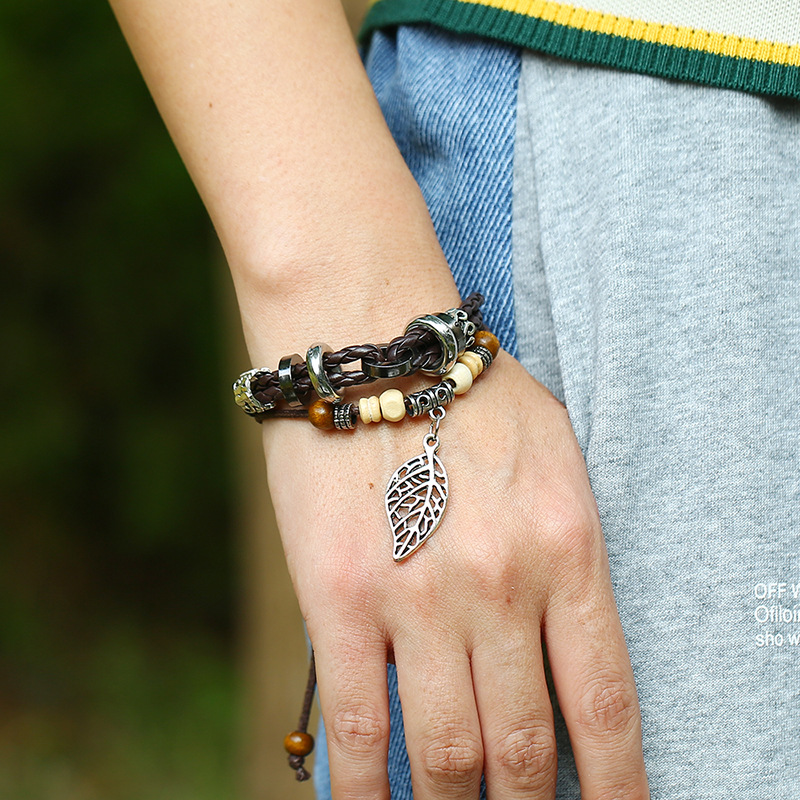 Korean version of imitation cowhide bracelet simple wild alloy leaf pendant woven leather bracelet