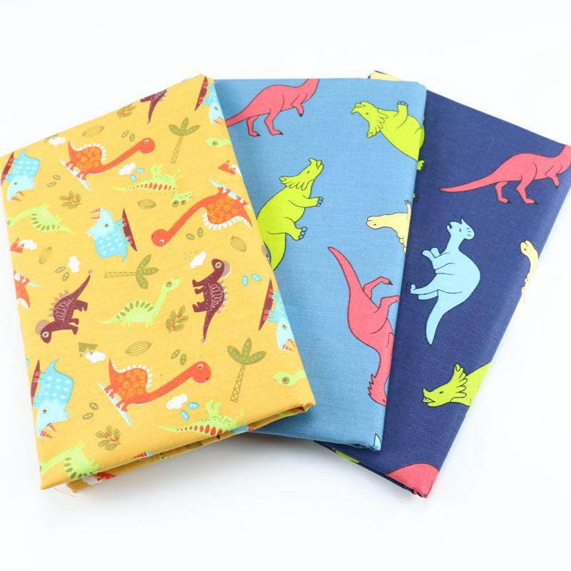 恐龙印花布料 婴幼儿床品套件布料 宝宝罩衣防晒衣帽斜纹面料批发