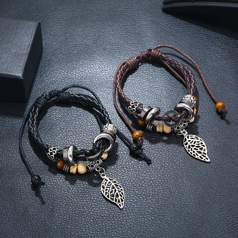 Korean Version Of Imitation Cowhide Bracelet Simple Wild Alloy Leaf Pendant Woven Leather Bracelet display picture 1
