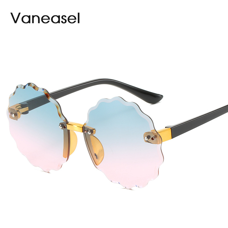 En stock al por mayor sin marco corte redondo onda encaje gafas de sol para niños moda multicolor océano pieza niños gafas de sol