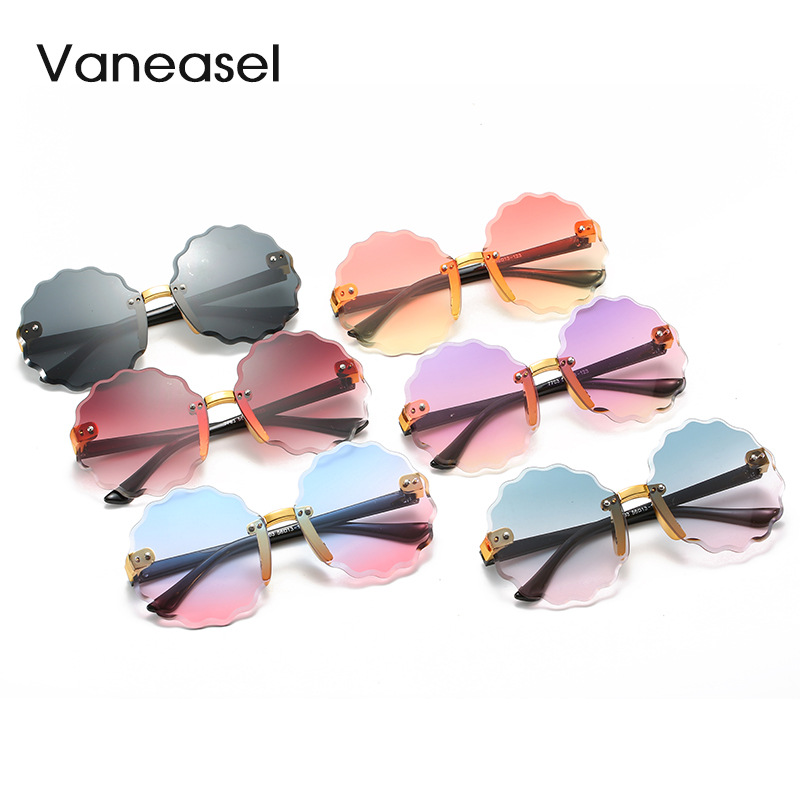 En stock al por mayor sin marco corte redondo onda encaje gafas de sol para niños moda multicolor océano pieza niños gafas de sol