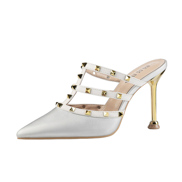 Slender riveted women’s sandals with thin heels and empty shoes 