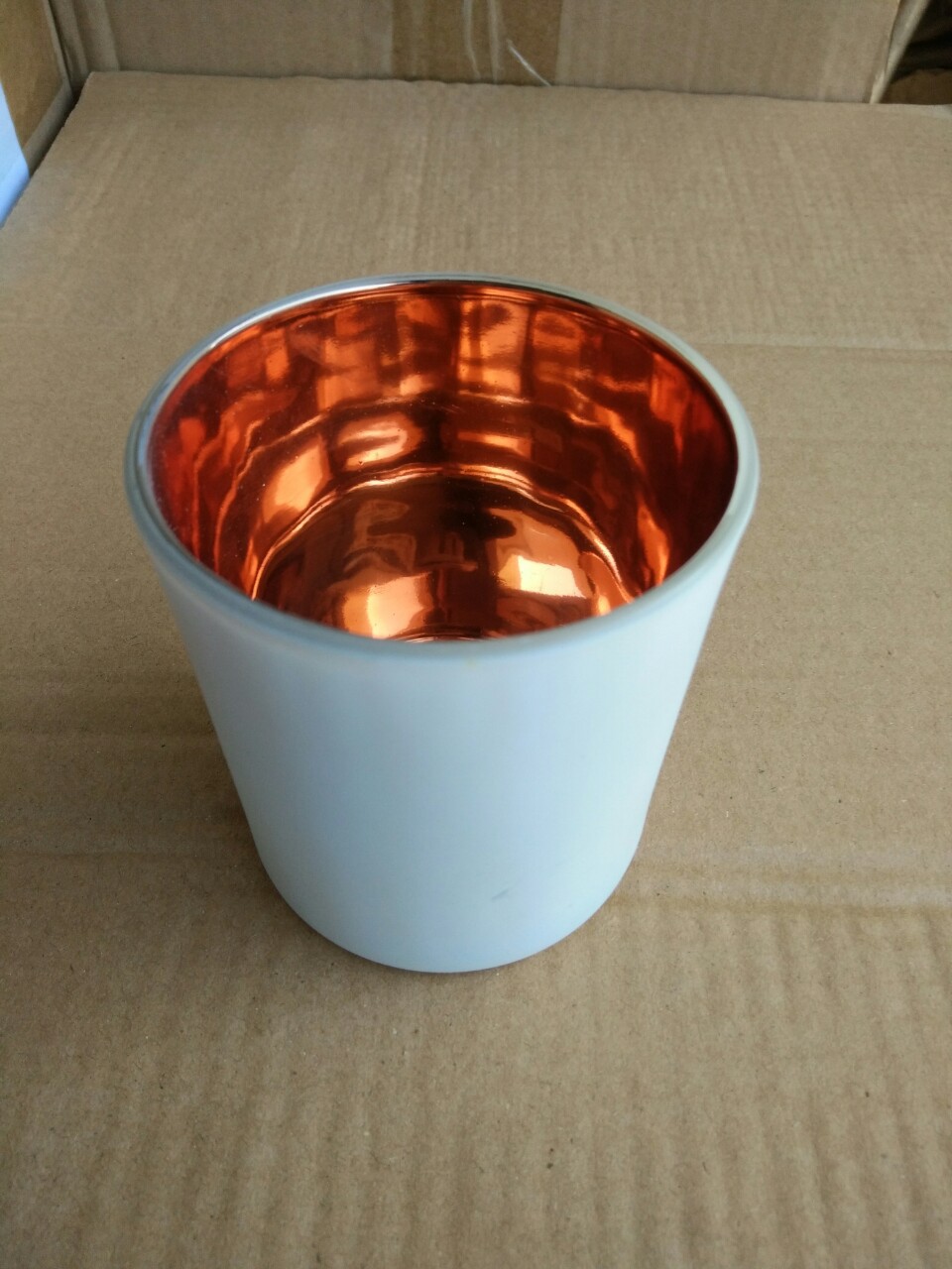 Glass matte white golden candle contains rose