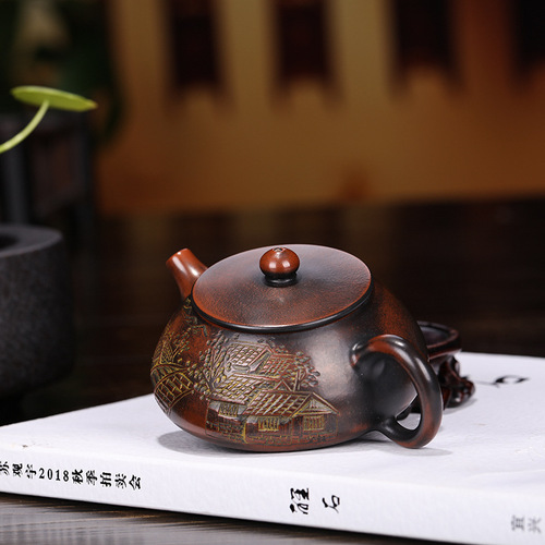 Yixing purple clay teapots are handmade and customized by famous manufacturers. Wholesale and delivery services. High-quality Nixing pottery carved and painted stone ladle teapots.