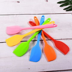 A one-piece all-silicone cream cheese spatula and cake decorating tool with a scraping and stirring function.