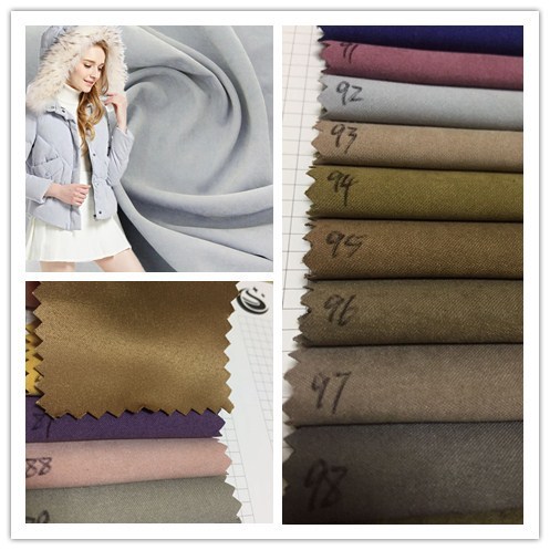 现货供应缎纹色丁雪花绒面料羽绒服风衣面料仿鹿皮绒公仔抱枕面料