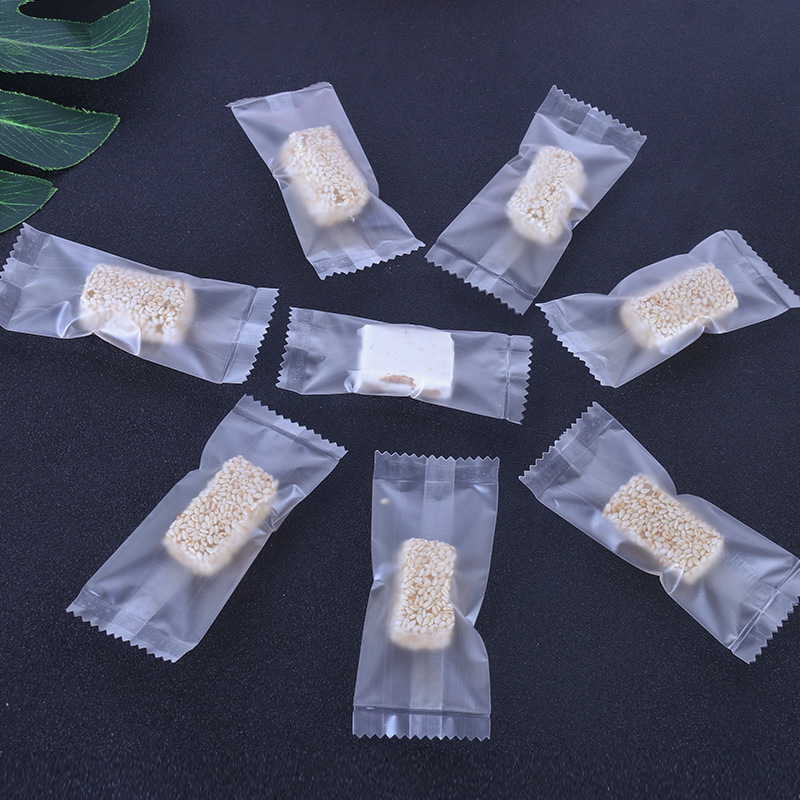 廠家批發卡通牛軋糖機封袋批發磨砂鋸齒糖果包裝袋多款式