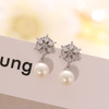 Zirconium from pearl, fashionable earrings, with snowflakes