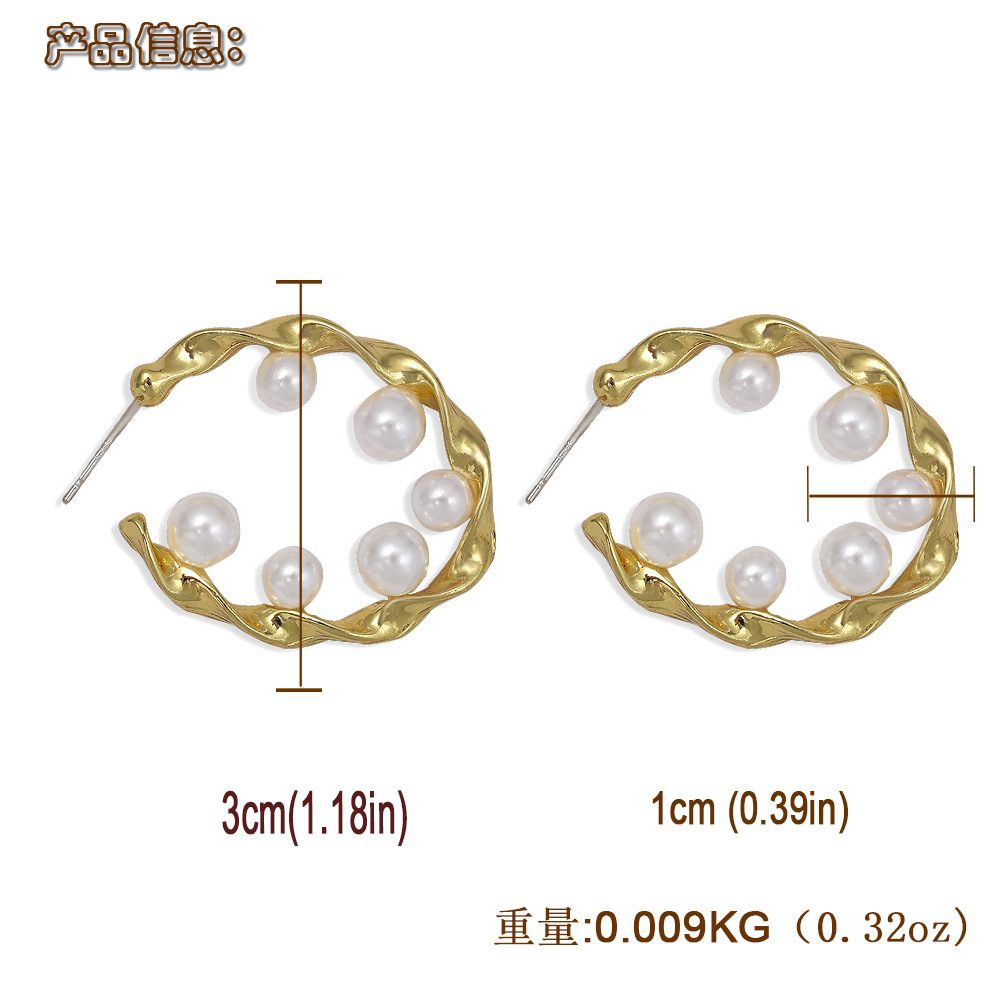 Pure White Pearl Inlaid Wavy Round Hollow Creative Fashion Earrings Wholesale display picture 3