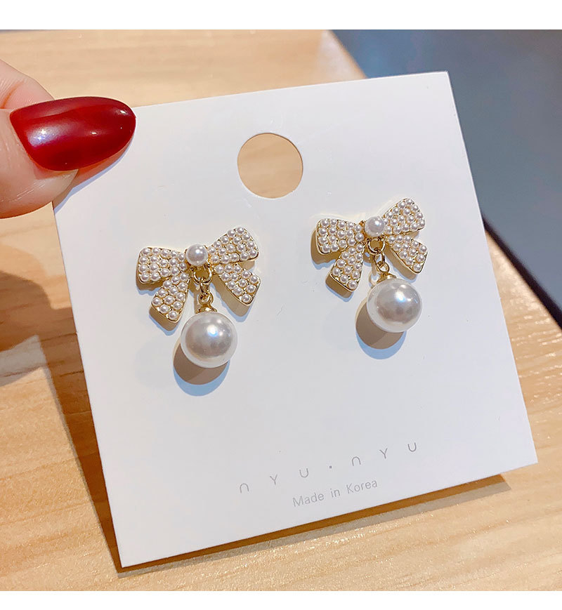 Korean Fashion Bow Inlaid Pearl Copper Drop Earrings Female display picture 3