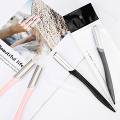 Black resin-handle eyebrow trimmer with stainless steel blade, protective mesh design—stylish and safe eyebrow tool for makeup artists.