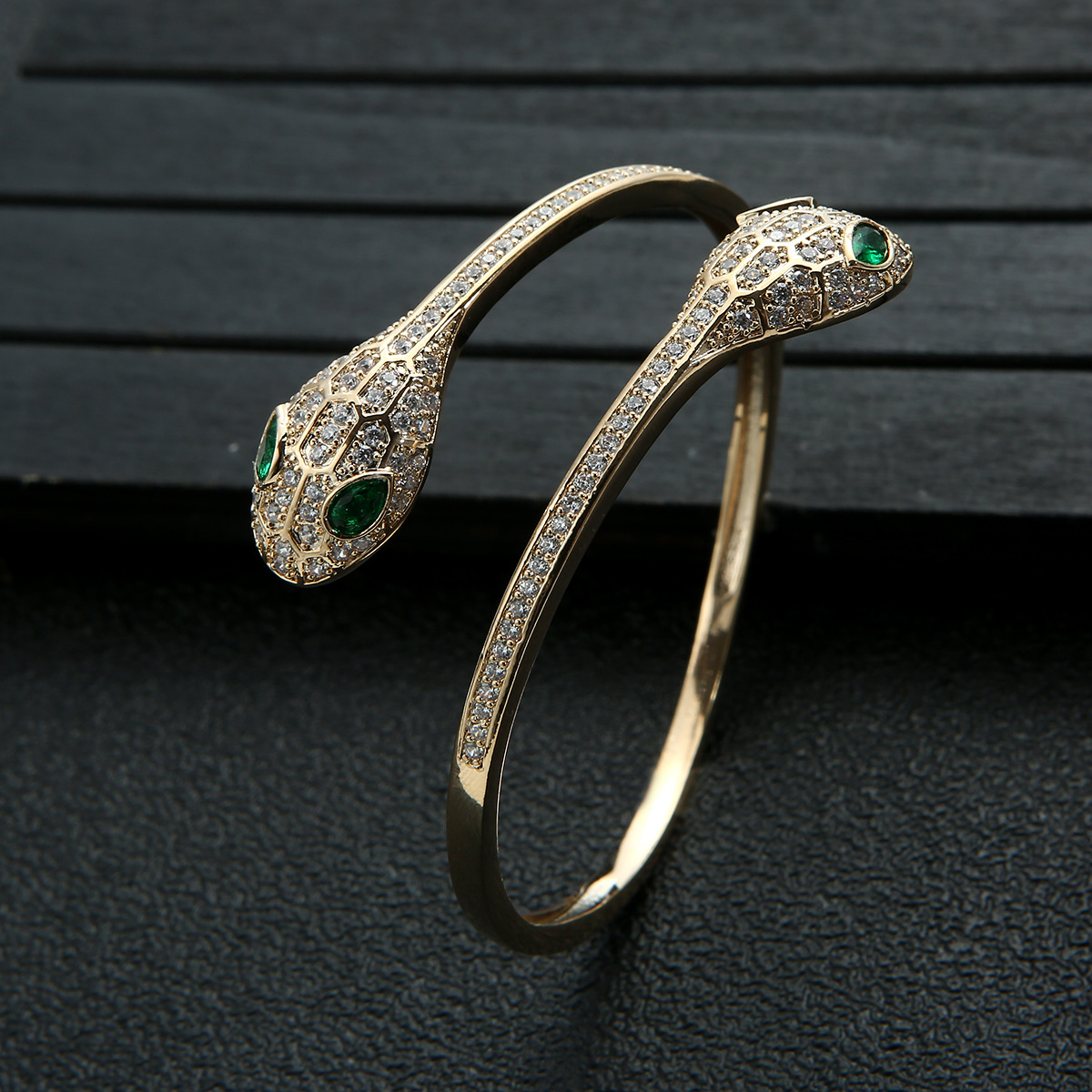 Green-eyed snake bracelet full of diamon...