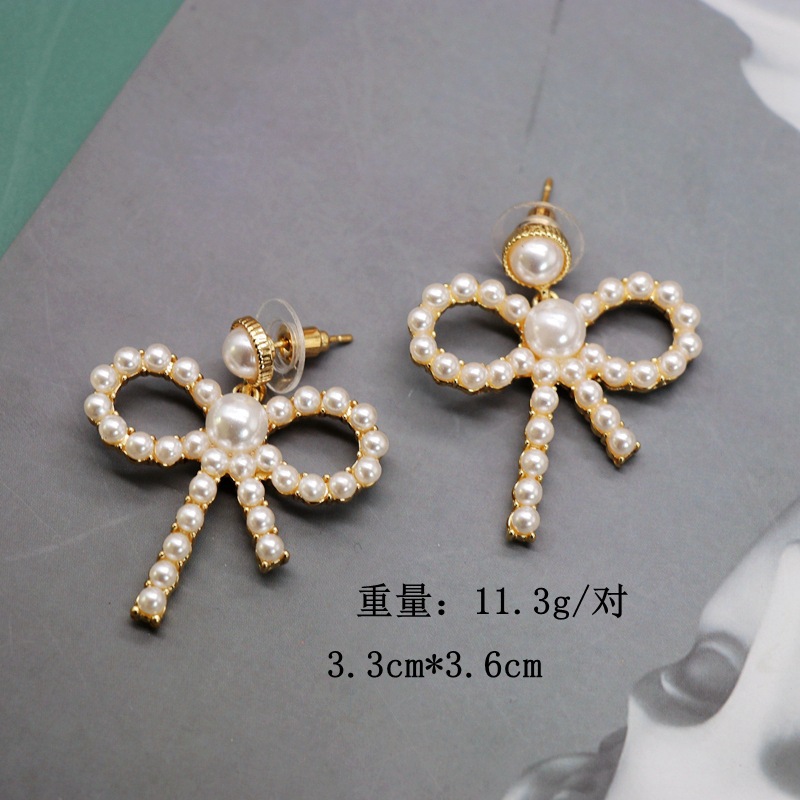 Hollow Bow Silver Needle Earrings Small Pearl Elegant Bow Knot Earrings Sweet Earrings Al Por Mayor Nihaojewelry display picture 1