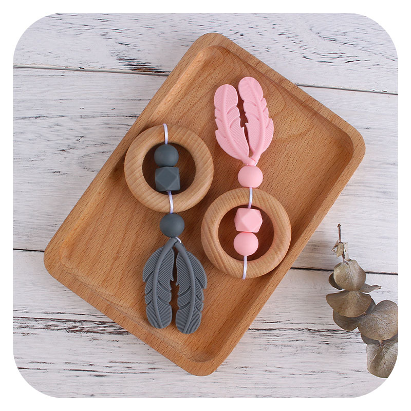 Nueva historieta DIY Beech anillo de mano molar de juguete mordedor infantil pluma de silicona perlas dientes de molienda palo