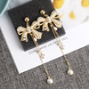 Silver needle with bow, long elegant fashionable earrings from pearl with tassels, diamond encrusted, silver 925 sample